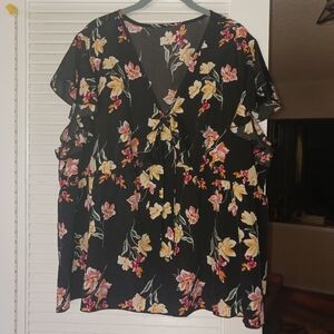 Flowing black blouse with flowers and front bow detail. Plus size